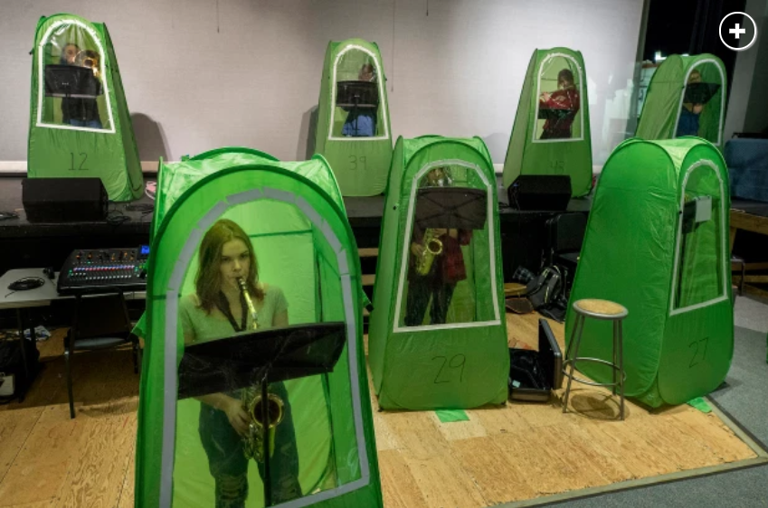 Students in individual tent pods for band class